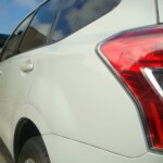 Before and after photographs of a damaged white Subaru that was repaired by Elite Paint & Body Shop in West Palm Beach, Florida